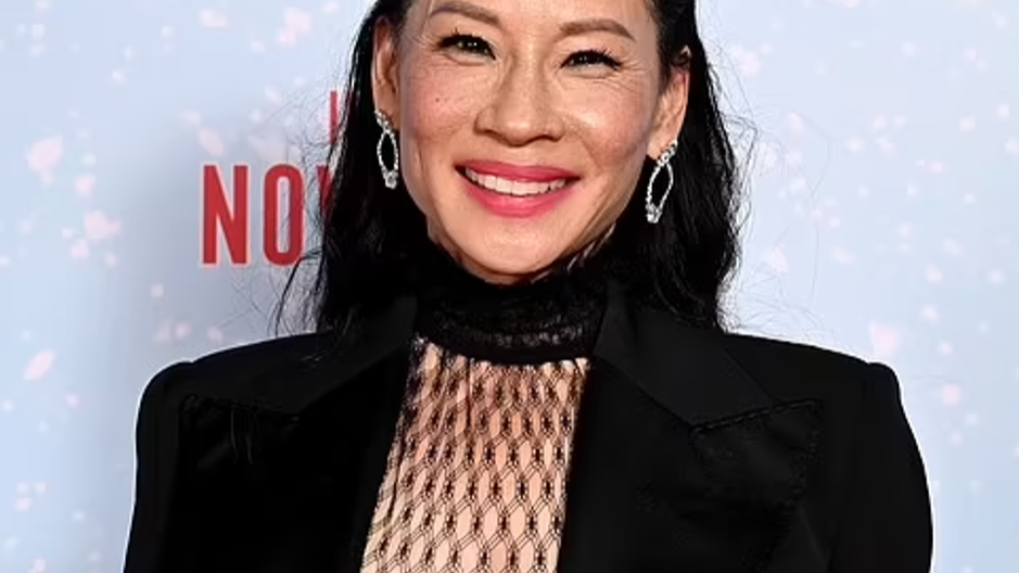 Lucy Liu flashes her legs in sheer tights as she joins Dwayne 'The Rock' Johnson at Red One screening